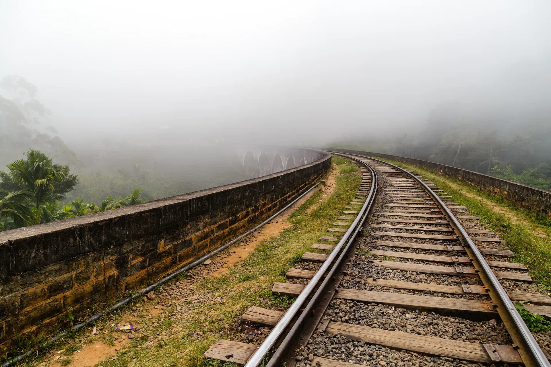 Curving railway line in the misty Ella hills