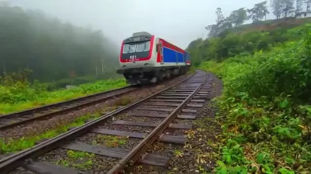 Blue train traveling through Sri Lanka's scenic hill country