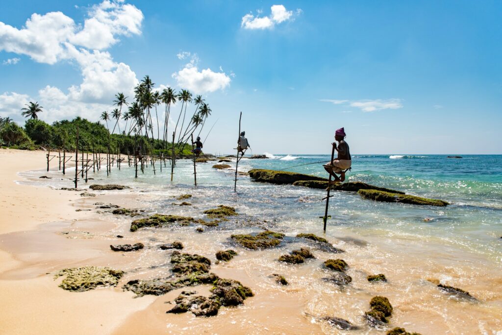 group of people climbing on stand beside seashore