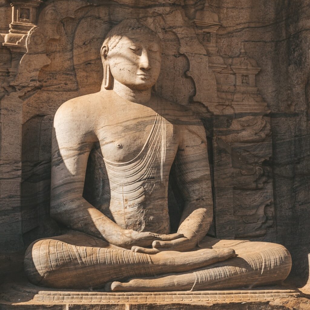 a statue of a person sitting in a lotus position