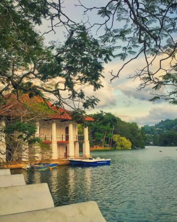 white and brown concrete building near body of water during daytime