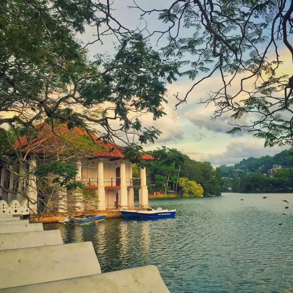 white and brown concrete building near body of water during daytime